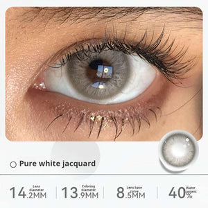 Close-up of an eye wearing "Pure white jacquard" contact lenses, showing a subtle, light gray, nearly translucent effect. Specifications: 14.2mm diameter, 13.1mm graphic diameter, 8.5mm base curve, 40% water content.
