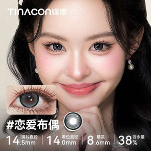 Model wearing Tinacon Love Doll gray contact lenses with 38 percent hydration and a defined edge.