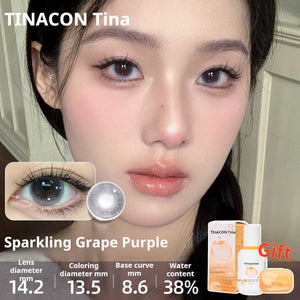Close-up of an eye wearing Sparkling Grape Purple lenses, showing a rich multi-toned lavender shade. Specs: 14.2mm diameter, 13.5mm graphic diameter, 8.6mm base curve, 38% water content.