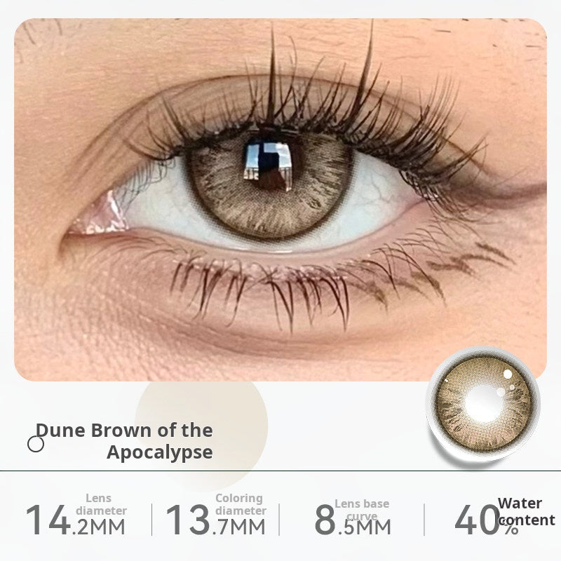 Close-up of an eye wearing "Dune Brown of the Apocalypse" contact lenses, showing a natural light brown shade. Specifications: 14.2mm diameter, 13.2mm graphic diameter, 8.5mm base curve, 40% water content.