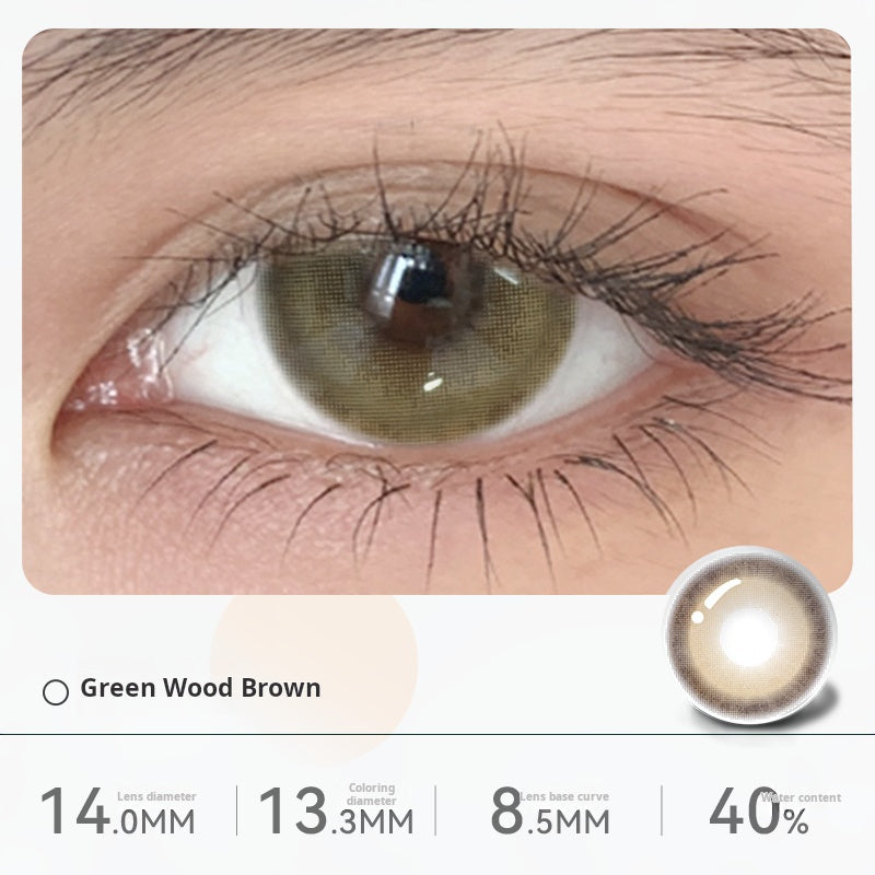 Close-up of an eye wearing "Green Wood Brown" contact lenses, displaying a subtle olive-green tint blended with brown. Specifications: 14.0mm diameter, 13.3mm graphic diameter, 8.5mm base curve, 40% water content.