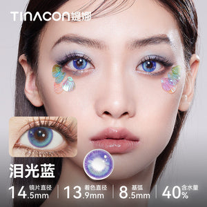 Model showcasing Tinacon Tears Blue aesthetic contact lenses with a soft gradient design and 40 percent water content.